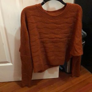 A dark orange sweater